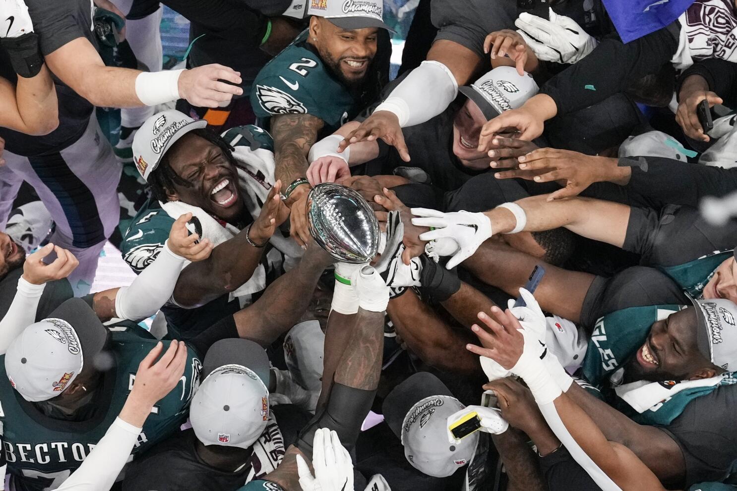 Philadelphia Eagles players celebrate with the Vince Lombardi Trophy after the Eagles won the NFL Super Bowl 59 football game against the Kansas City Chiefs, Sunday, Feb. 9, 2025, in New Orleans. (AP Photo/David J. Phillip)